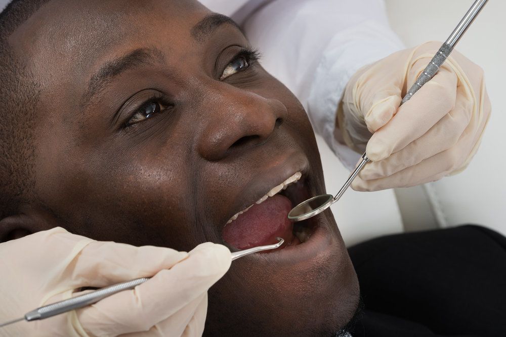 Doctor Hands Doing Dental Check Up Of Male Patient